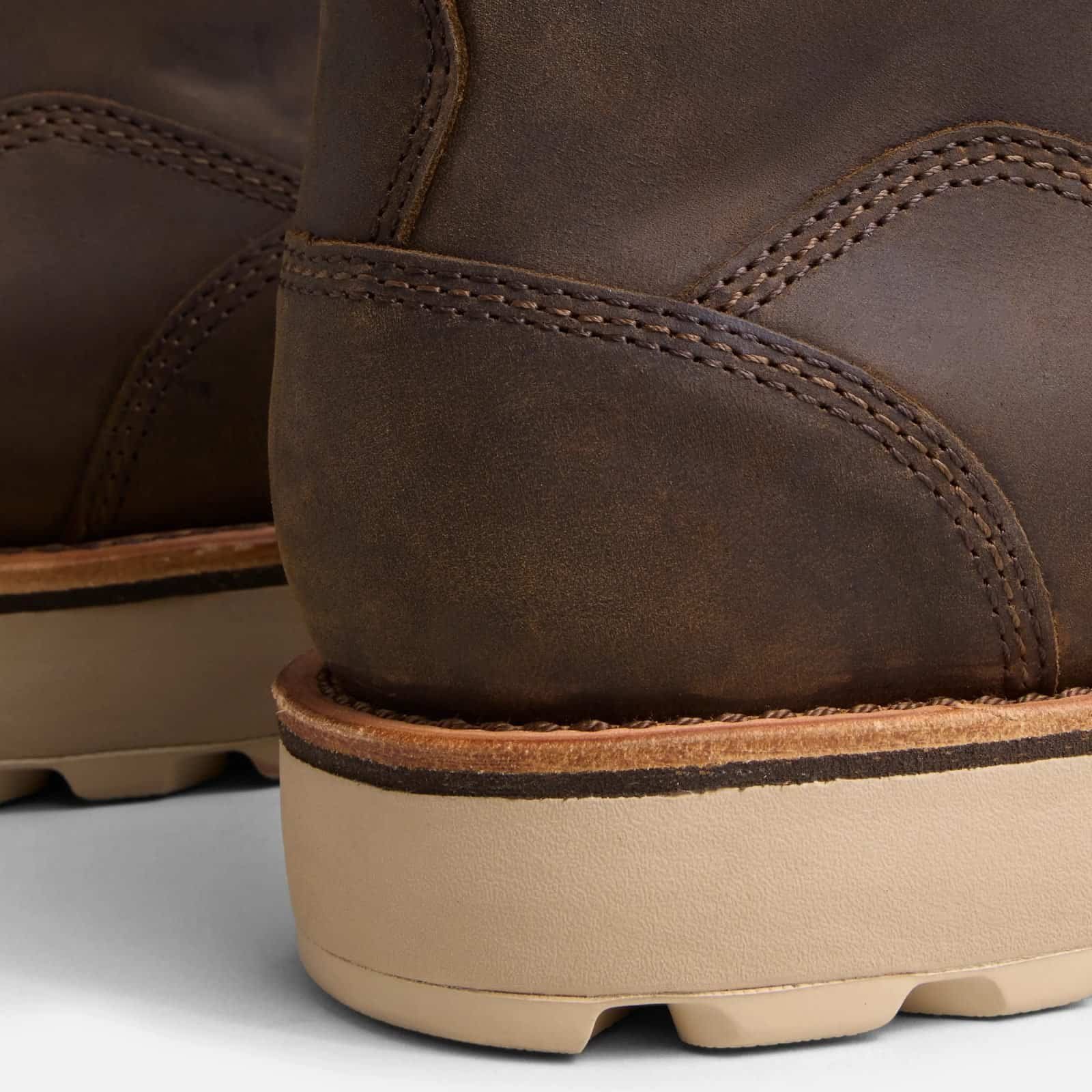 Close-up of the heel counter on the Anzhou 301 brown leather waterproof safety boot, showing stitching detail and wedge sole